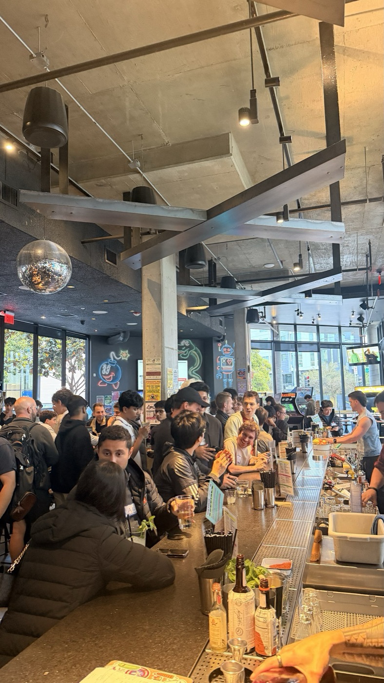 A packed founder meetup at an arcade bar